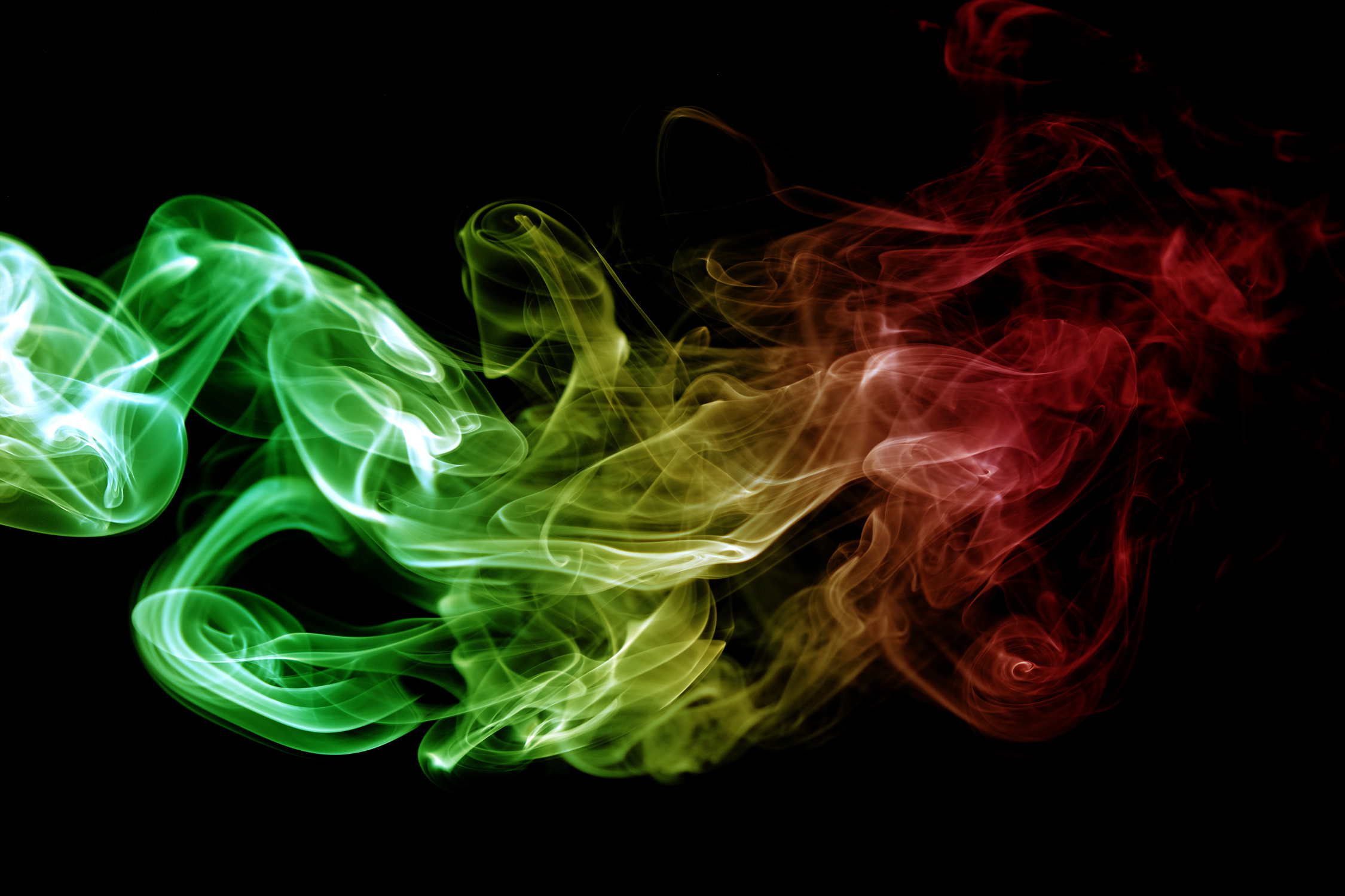 abstract background smoke curves and wave reggae colors green, yellow, red colored in flag of reggae music